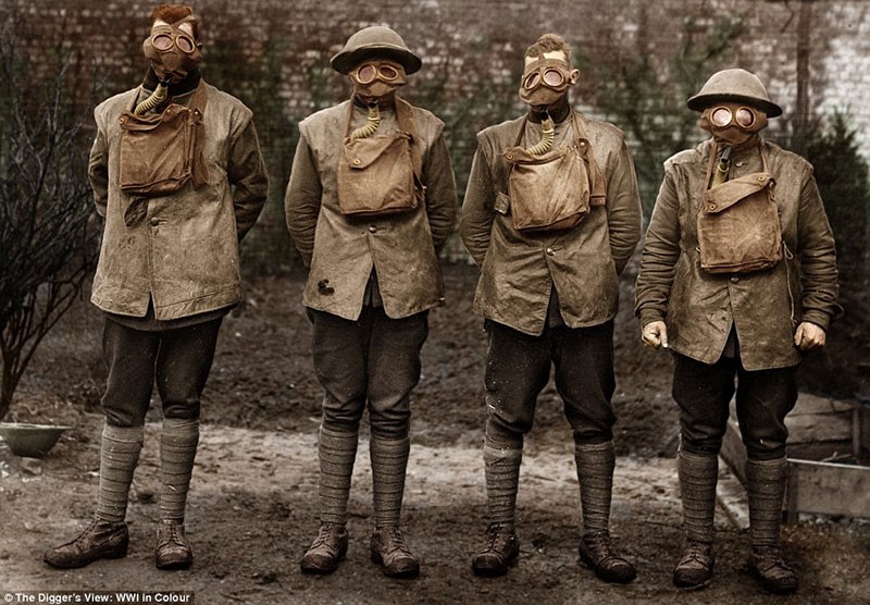 4 soldiers lined up in WW1 gas masks.