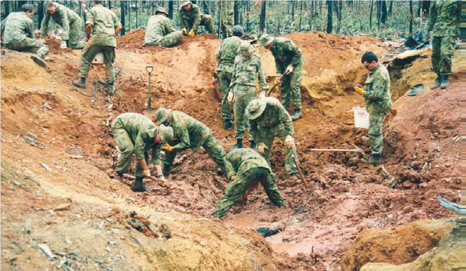 Soldiers digging in the dirt.