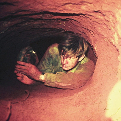 A tunnel rat in a narrow Viet Cong tunnel