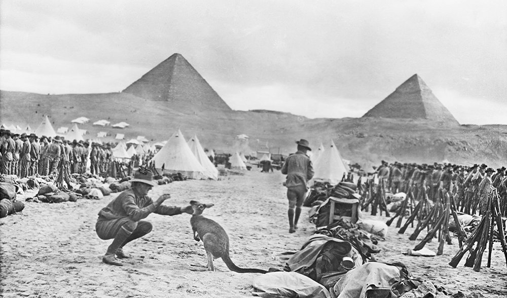 Soldier playing with a kangaroo, the regimental mascot.