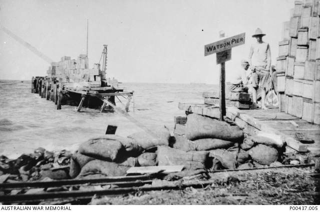 Two soldiers stand in front of Watson's Pier.