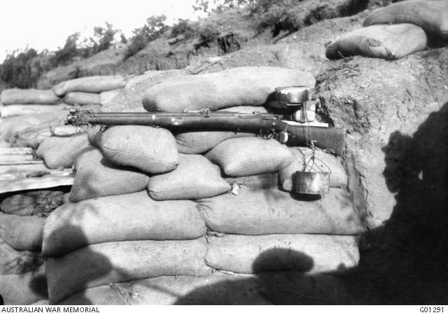 A delayed action device, commonly called a drip rifle for firing a rifle by means of weights operated through water escaping from one tin into another.