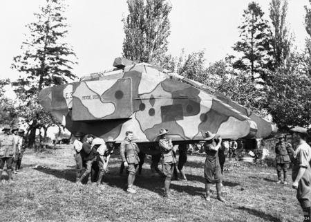 Soldiers carrying a decoy vehicle.