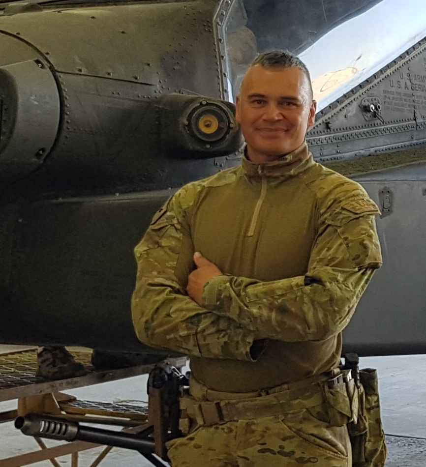 CPL Leighton Haywood-Smith in front of the AH64