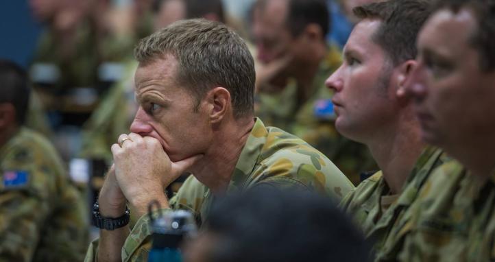 A soldier in a lecture hall.
