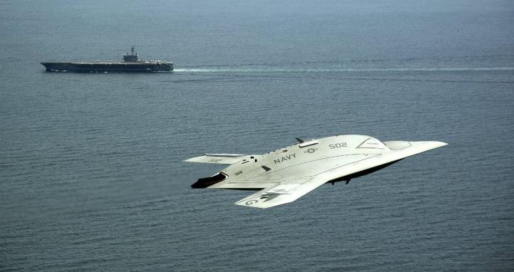 A plane flying above the ocean.