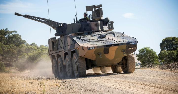 A Rheinmetall Boxer CRV drives off of the Armoured Fighting Vehicle.