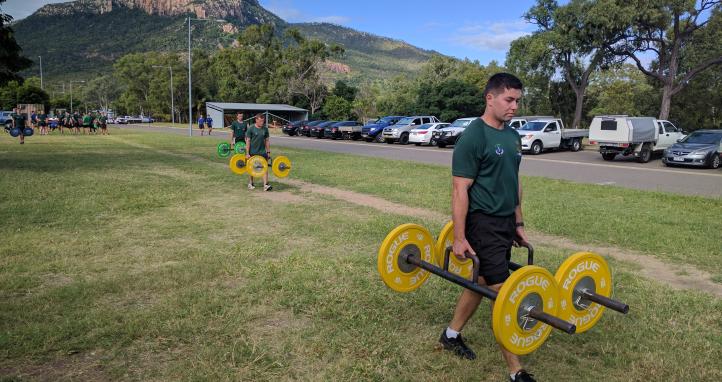 A soldier carrying weights.