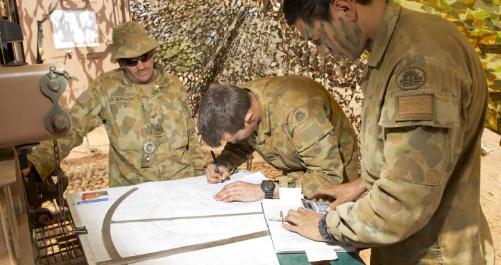 Soldiers looking at a map.