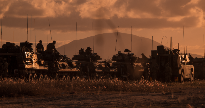 Army vehicles at dusk.