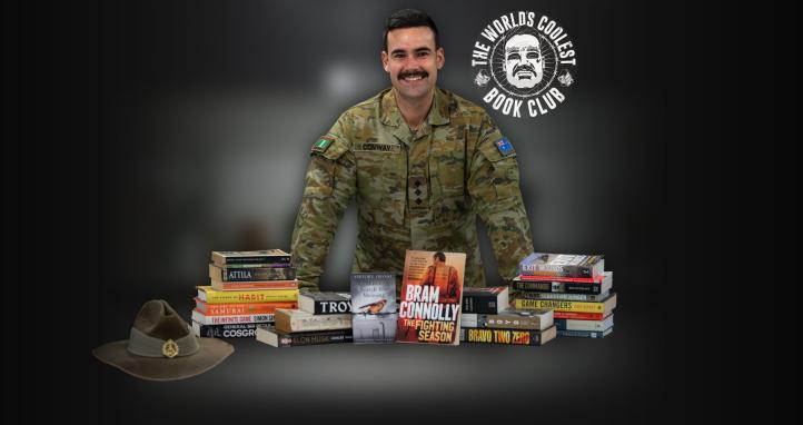 Dylan Conway standing behind books.