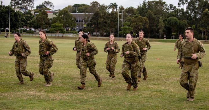 Soldiers running on an oval.