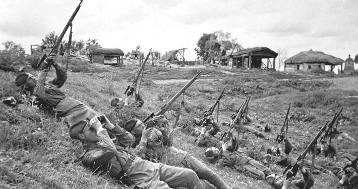 Soviet soldiers, on their backs, launch a volley of bullets at enemy aircraft in June of 1943.