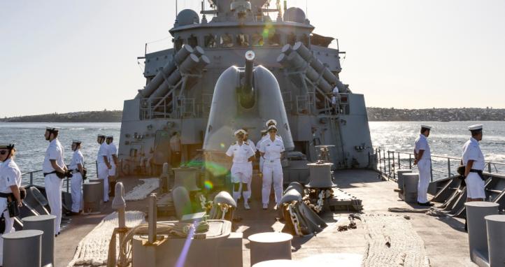 HMAS Arunta's ships company stand at ease as the ship returns to their home port of Fleet Base East, Sydney after completing a Regional Presence Deployment. 