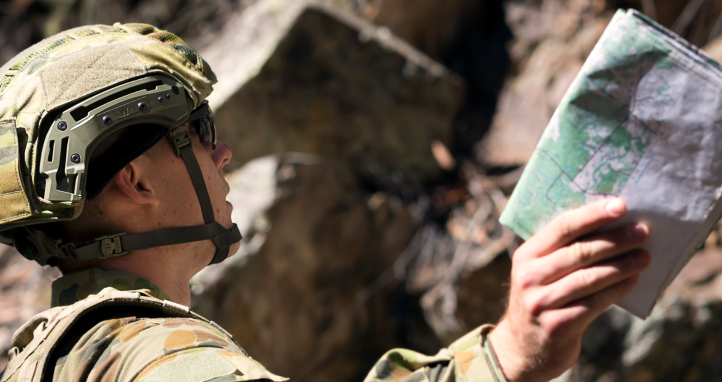 Staff Cadet signals another cadet during a navigation training exercise in Kowen Forest, Canberra.