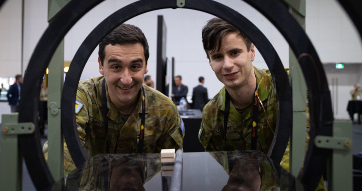 Two soldiers look at the Army Quantum Technology Challenge display.