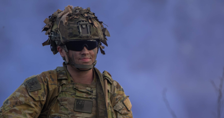 A soldier with blue smoke behind them.