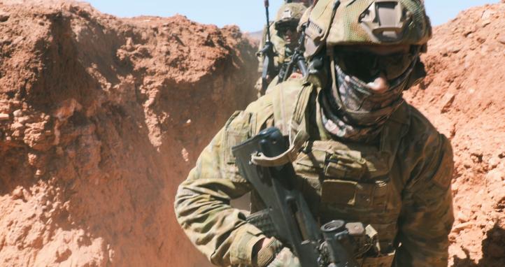 Soldiers running in trenches.