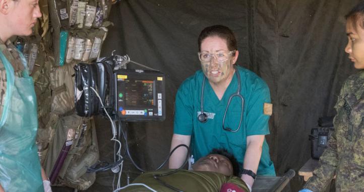 Combat medics treat a simulated casualty.