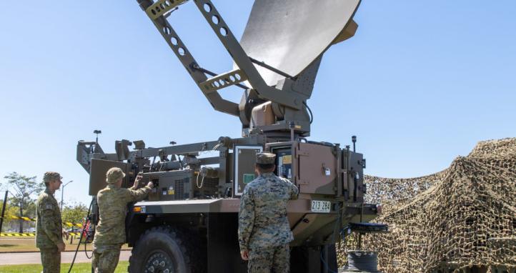 Australian Army Signallers showing a United States Marine Corps Lance Corporal a Medium Satellite Communications (SATCOM) Terminal.