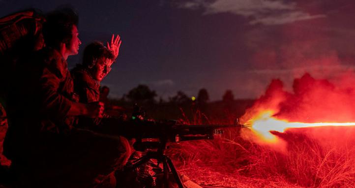 Australian Army soldiers firing the MAG 58 at night.