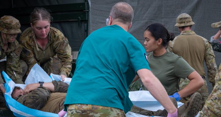 Medical staff from the Australian Army's 3rd Health Battalion and the United States Navy unload a simulated casualty.