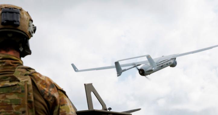 An Australian Army soldier launches an Integrator UAV.