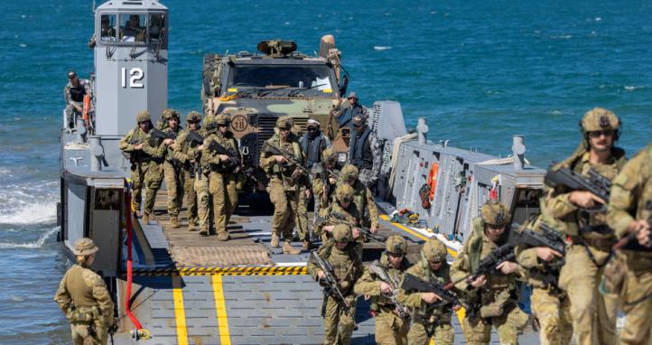 Australian Army soldiers from the Australian Amphibious Force disembark a Littoral Landing Craft during Wet and Dry Environment Rehearsals at Cowley Beach Training Area.