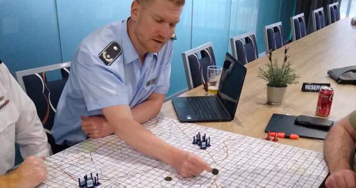 Australian military personnel play a wargame.
