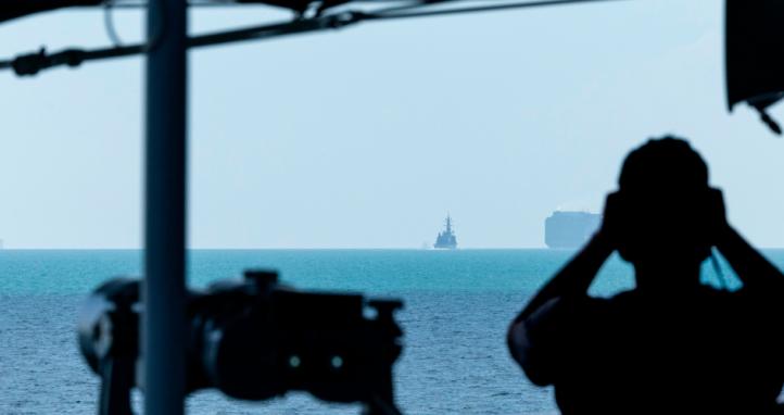 A Boatswain's Mate observes JS Yudachi navigating the Malacca Strait while in company with HMAS Warramunga.