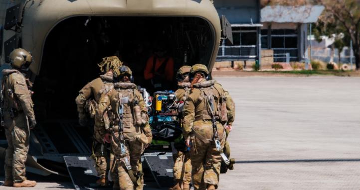 Members of the 4th Health Battalion load a simulated casualty during aeromedical evacuation training.