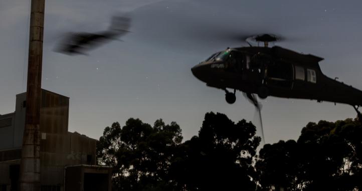 Australian Army UH-60M Black Hawks insert Australian Army soldiers onto a target.