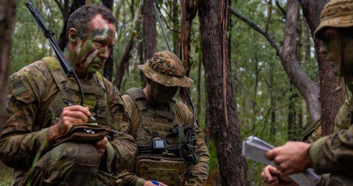 An Australian Army soldier receives orders from his platoon commander before a patrol.