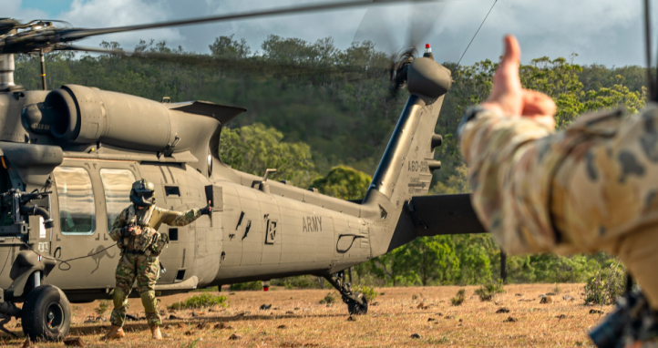 Australian Army soldiers prepare to embark an Australian Army UH-60M Black Hawk.