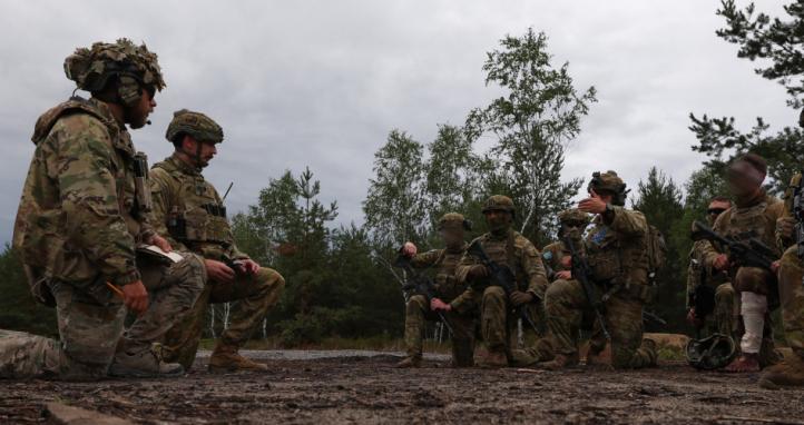 Australian Army soldiers conduct a debrief with an instructor from the Armed Forces of Ukraine after an urban clearance.