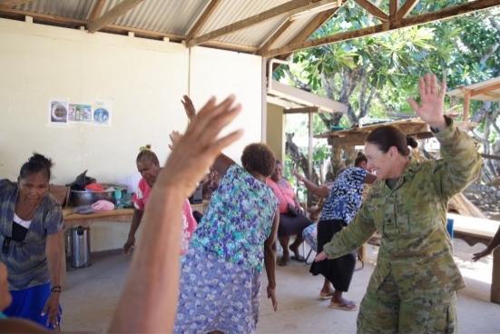 Chaplain Kerrie Frizzell and local women enjoying cultural dance