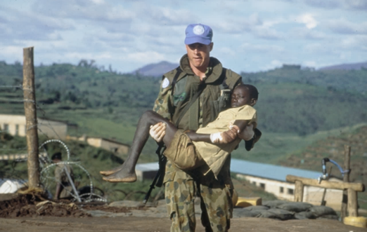 A UN soldier carrying a child.