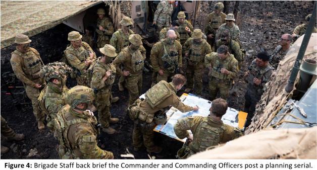 Brigade Staff back brief the Commander and Commanding Officers post a planning serial.