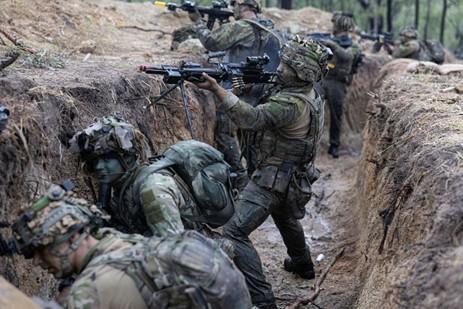 New Zealand Army soldiers attack enemy trenches.