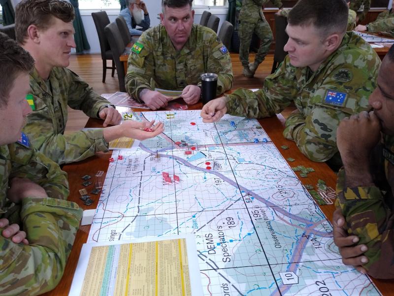 Officers at the School of Infantry participate in a wargame using Australian Platoon Commander during a PME session.