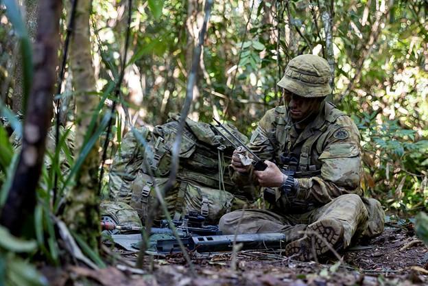 Australian Army Trooper Mark Savage from the 2/14th Light Horse Regiment cleans his EF88 Austeyr Rifle during morning routine at the Combat Training Centre – Jungle Training Wing, Tully, Queensland.