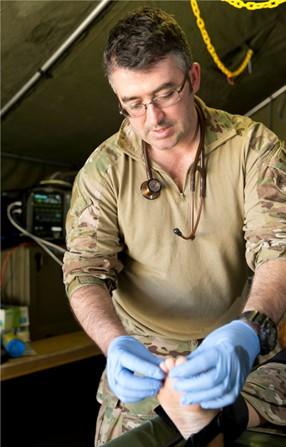 Australian Army soldier Corporal Luke Hayes, an advanced medical technician from 4th Combat Service Support Battalion, conducts a free from infection check during Exercise Diamond Strike at Shoalwater Bay training area, Queensland, in June 2015.