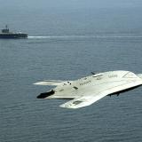 A plane flying above the ocean.