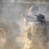 Two soldiers holding a rocket launcher.