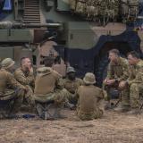 Soldiers sitting around in a circle.