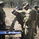 Soldiers looking at a map in the bush.