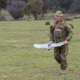 A soldier carrying a drone.