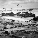 Loading ships putting cargo ashore on Omaha Beach.