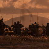 Army vehicles at dusk.