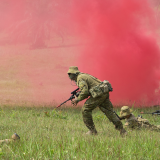 Australian Army soldiers demonstrate in a field.